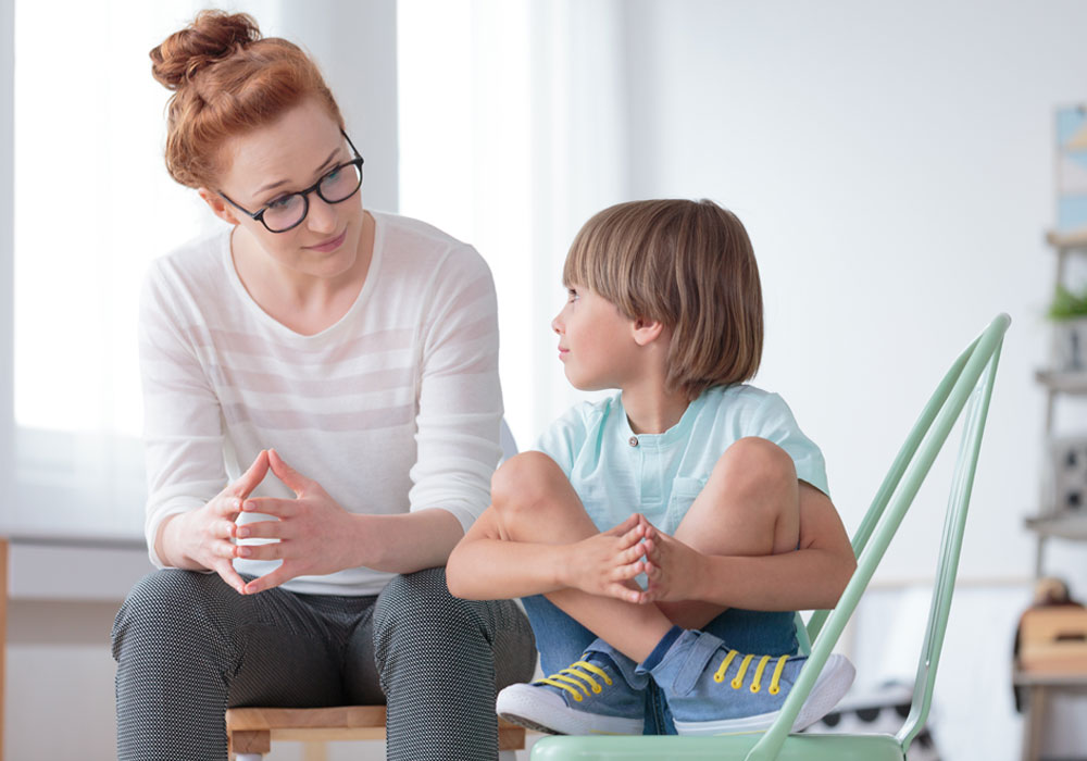 adult talking to a young child 