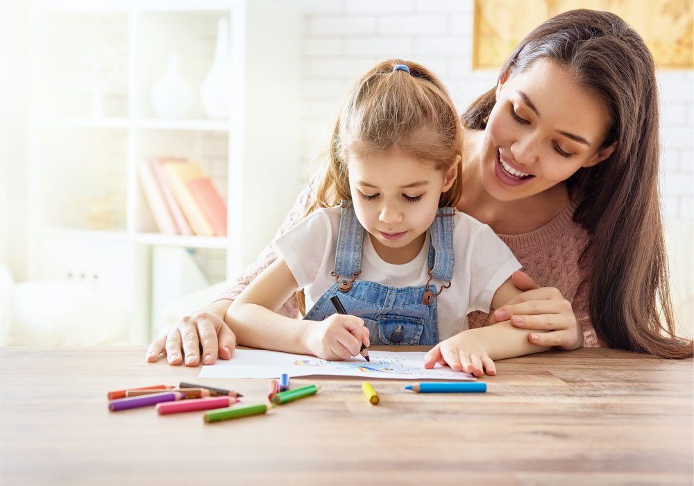 Adult helping child draw a nice picture 