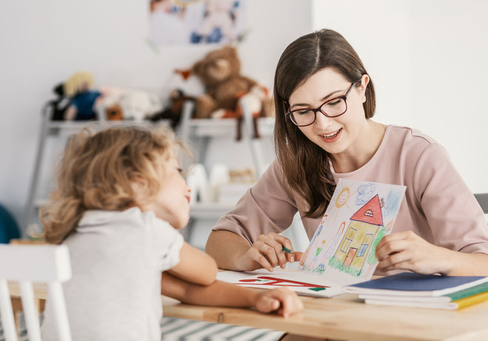 adult showing drawing to a child 